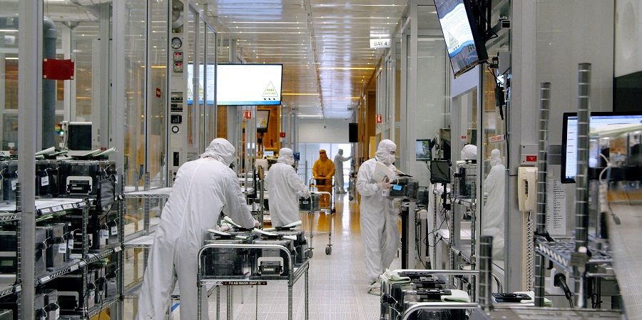 Workers work inside the clean room of US semiconductor manufacturer SkyWater Technology Inc where computer chips are made, in Bloomington, Minnesota, US, in April 2022 in this handout picture acquired by Reuters on 19 July 2022. (SkyWater Technology/Handout via Reuters/File Photo)