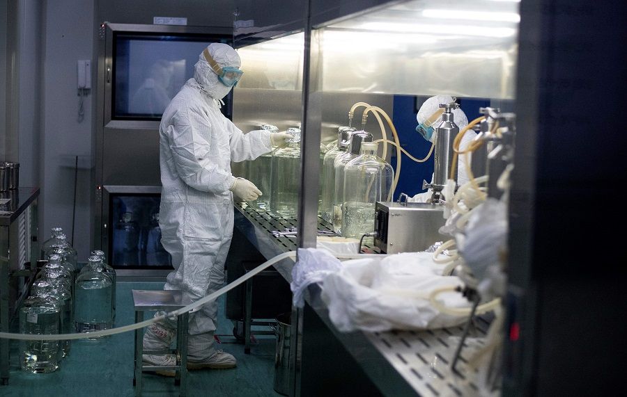This file photo taken on 10 June 2020 shows a researcher working in a lab at the Yisheng Biopharma company where researchers are trying to develop a vaccine for the Covid-19 coronavirus, in Shenyang, Liaoning. (Noel Celis/AFP)