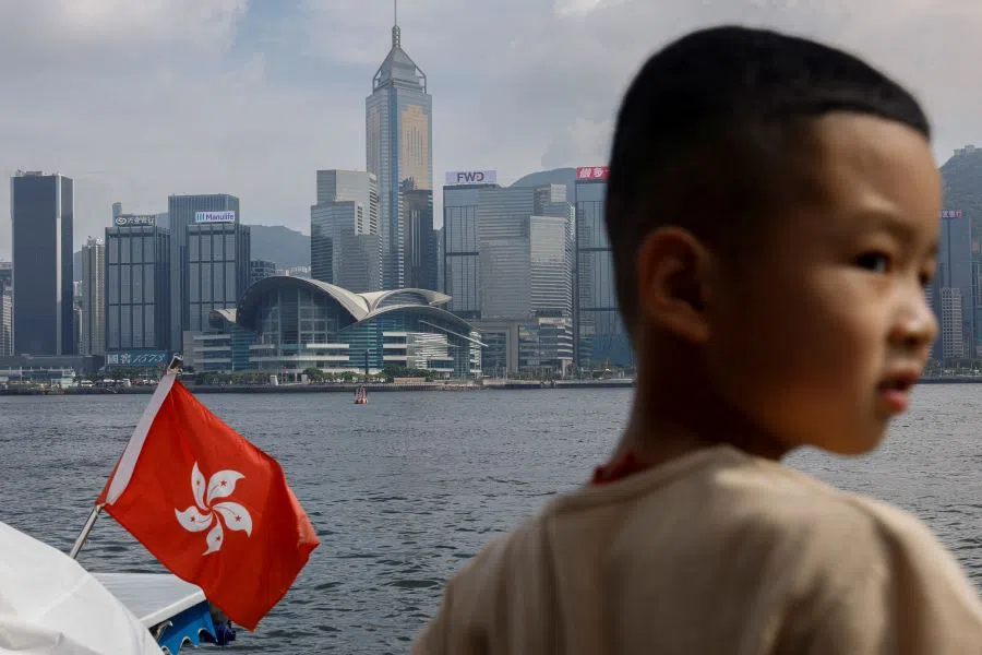 A child stands next to a vessel with a Hong Kong flag at Victoria Harbour in Hong Kong, China, 30 August 2024.