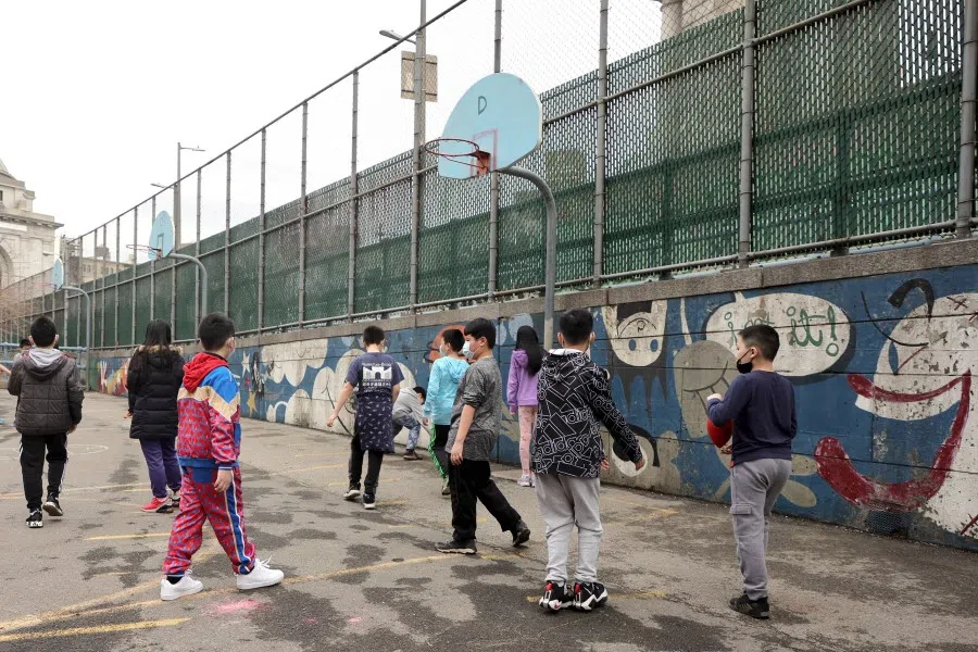 Students play at recess on an outdoor court at Yung Wing School P.S. 124 on 7 March 2022 in New York City. (Michael Loccisano/AFP)