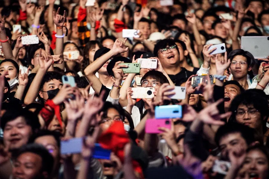 This photograph taken on 1 May 2021 shows people watching a performance at the Strawberry Music Festival in Wuhan, in China's central Hubei province. (STR/AFP)