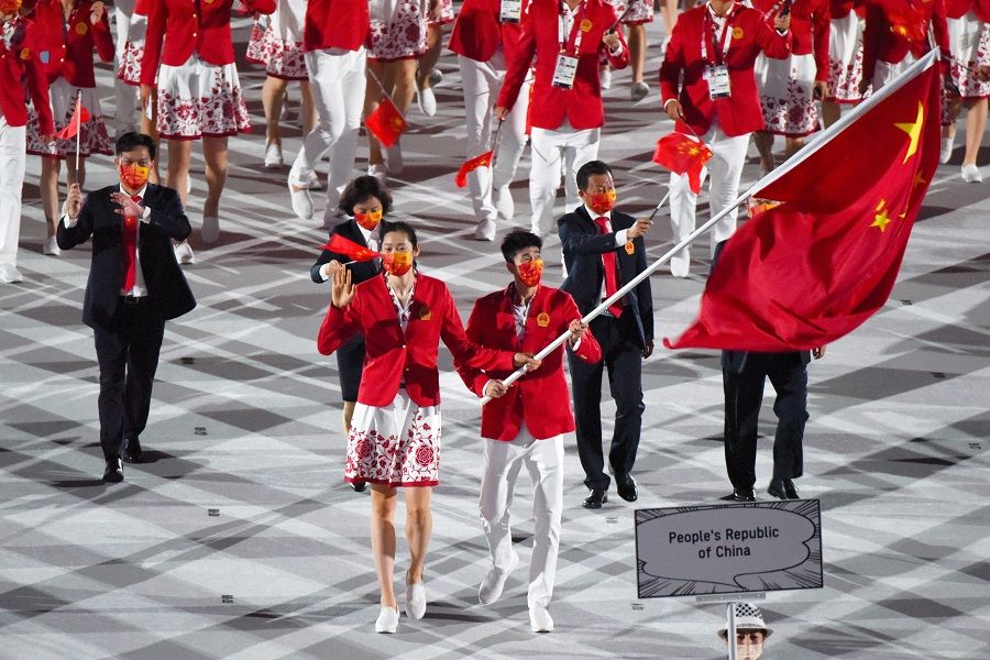 Flag bearers Zhu Ting and Zhao Shuai of Team China lead their delegation during the opening ceremony of the Tokyo 2020 Olympic Games at the National Stadium in Tokyo, Japan on 23 July 2021. (Noriko Hayashi/Bloomberg)