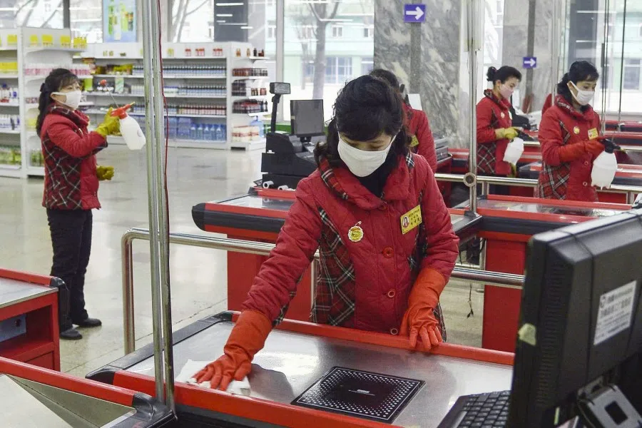 A woman disinfects to prevent new coronavirus infections at a department store in Pyongyang, North Korea, in this photo taken on February 28, 2020. (Kyodo/via REUTERS)