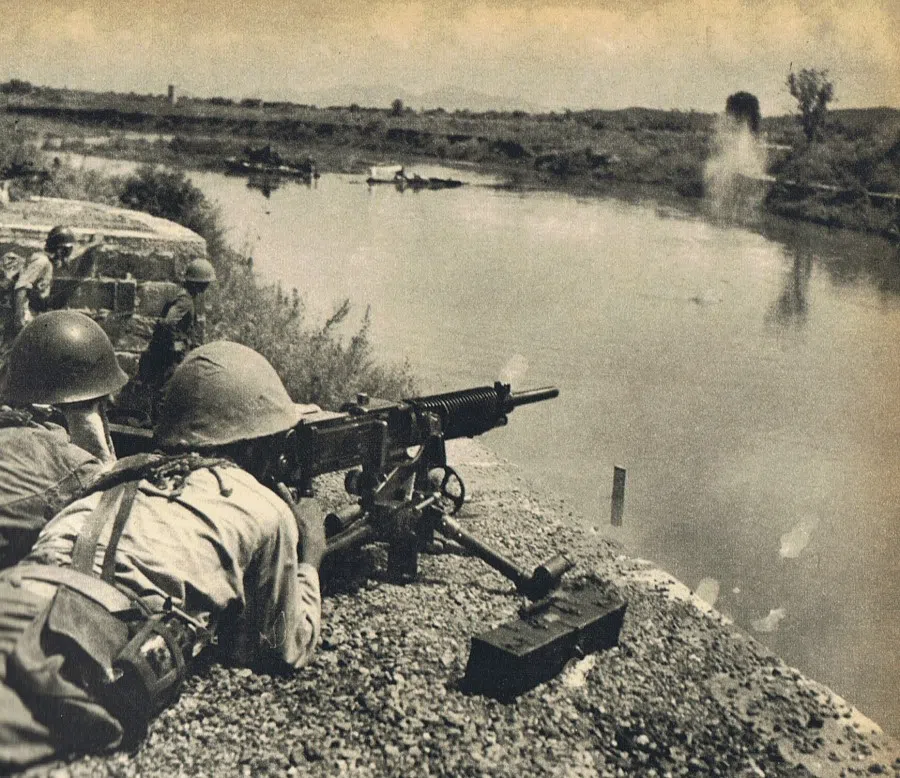 A soldier of the Imperial Japanese Army firing a machine gun in the Battle of Changsha near the Miluo River, Hunan province, China, on September 1941. (Wikipedia)