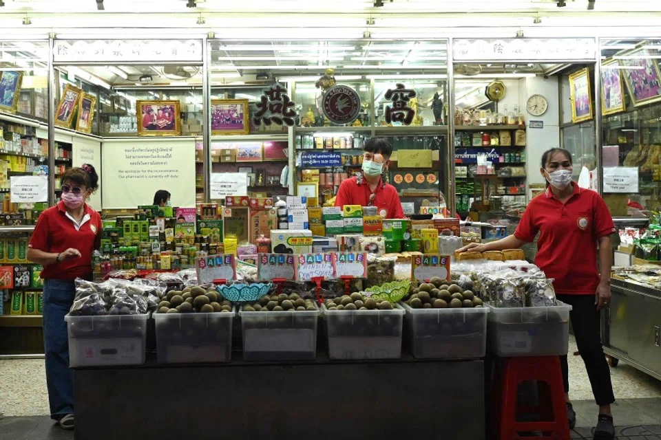 This photo taken on 4 July 2023 shows fruit vendors waiting for customers along a street in the Chinatown area of Bangkok. (Sai Aung Main/AFP)