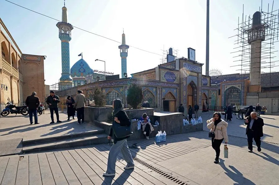 People walk past the Imamzadeh Saleh mosque at Tajrish Square in Tehran, Iran on 28 January 2026. (Atta Kenare/AFP)