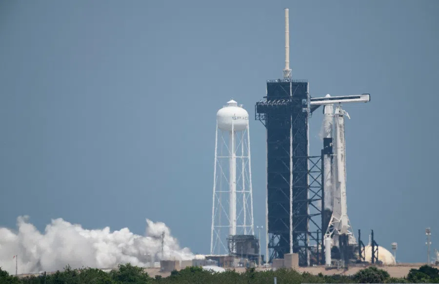 In this NASA handout photo, a SpaceX Falcon 9 rocket with the company's Crew Dragon spacecraft aboard is seen on the launch pad at Launch Complex 39A during a brief static fire test ahead of Axiom Mission 1 (Ax-1), 6 April 2022, at NASA's Kennedy Space Center in Florida, US. (Joel Kowsky/NASA/AFP)