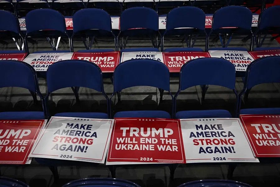 A sign reading “Trump Will End the Ukraine War” is set on attendees chairs during the third day of the 2024 Republican National Convention at the Fiserv Forum in Milwaukee, Wisconsin, on 17 July 2024. (Jim Watson/AFP)