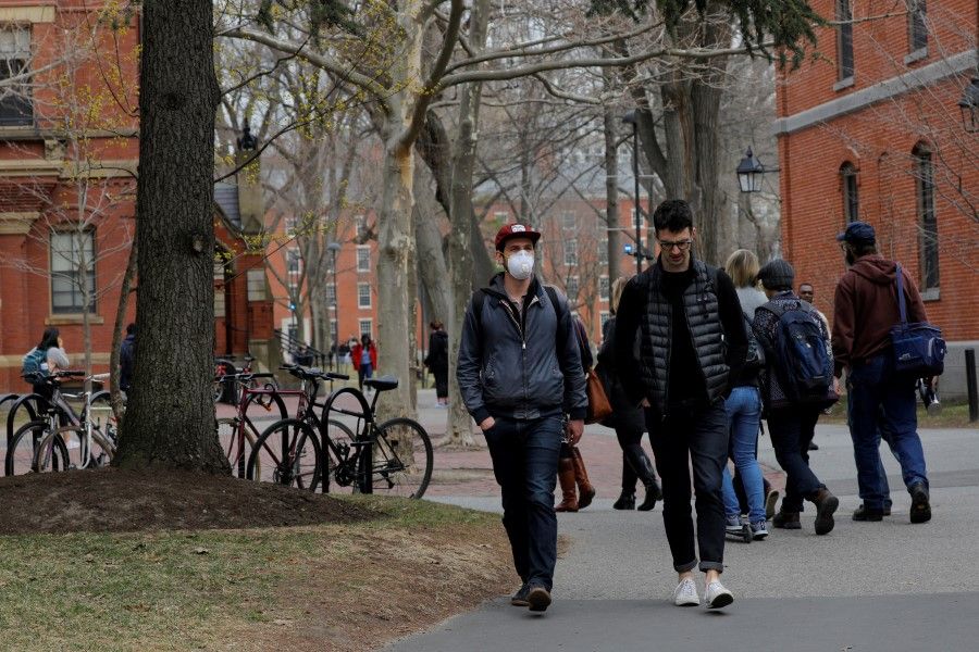 A student walks through the Yard at Harvard University, Cambridge, Massachusetts, US, 10 March 2020. (Brian Snyder/Reuters)
