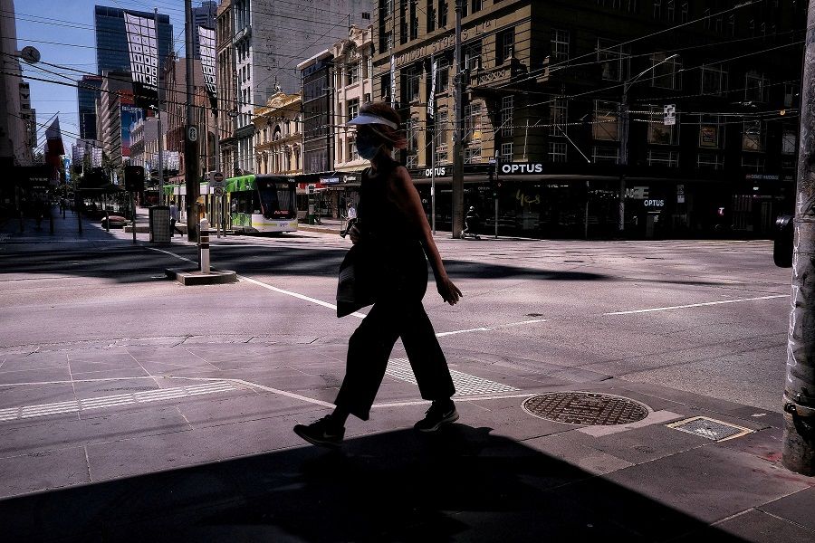 A woman walks on a street, amid a state-wide lockdown, in Melbourne city centre, Victoria, Australia, 15 February 2021. (AAP Image/Luis Ascui/via Reuters/File Photo)