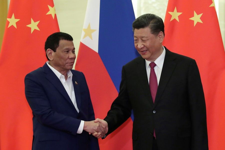 Philippine President Rodrigo Duterte shakes hands with Chinese President Xi Jinping before their meeting at the Great Hall of People in Beijing, China on 25 April 2019. (Kenzaburo Fukuhara/Pool via Reuters)