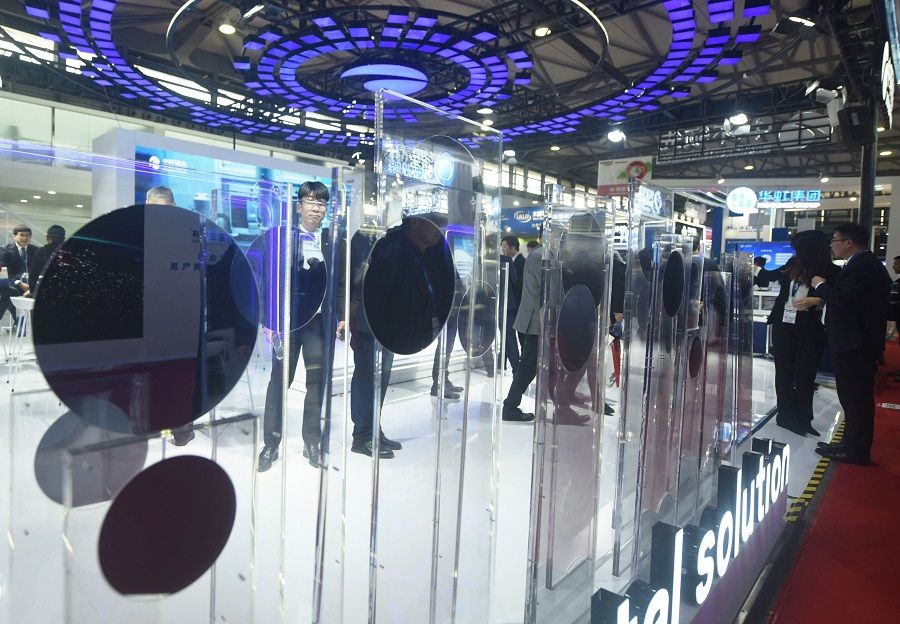 People look at displays at the Semicon China semiconductor exhibition in Shanghai, China, on 20 March 2024. (AFP)