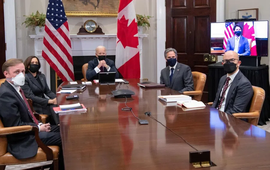 US President Joe Biden with US Vice President Kamala Harris (second from left), national security adviser Jake Sullivan (left), Secretary of State Antony Blinken (second from right) and deputy assistant secretary of state for western hemisphere affairs Juan Gonzalez (right) hold a virtual bilateral meeting with Canadian Prime Minister Justin Trudeau (on screen) in the Roosevelt Room of the White House in Washington, DC, 23 February 2021. (Saul Loeb/AFP)