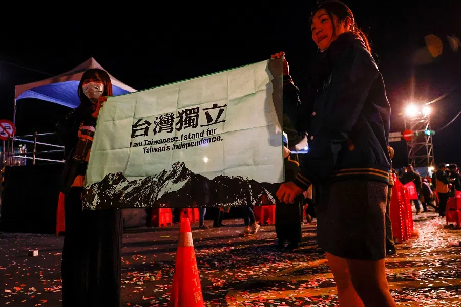 Supporters of the Democratic Progressive Party (DPP) pose for a picture holding a pro-Taiwan independent flag during a rally, following the victory of Lai Ching-te in the presidential elections, in Taipei, Taiwan, on 13 January 2024. (Ann Wang/Reuters)