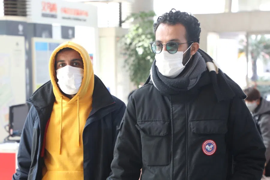 Two foreign buyers at Yiwu International Trade City, sourcing for items to buy. There are concerns about illegal immigrants becoming legal residents in China. (CNS)