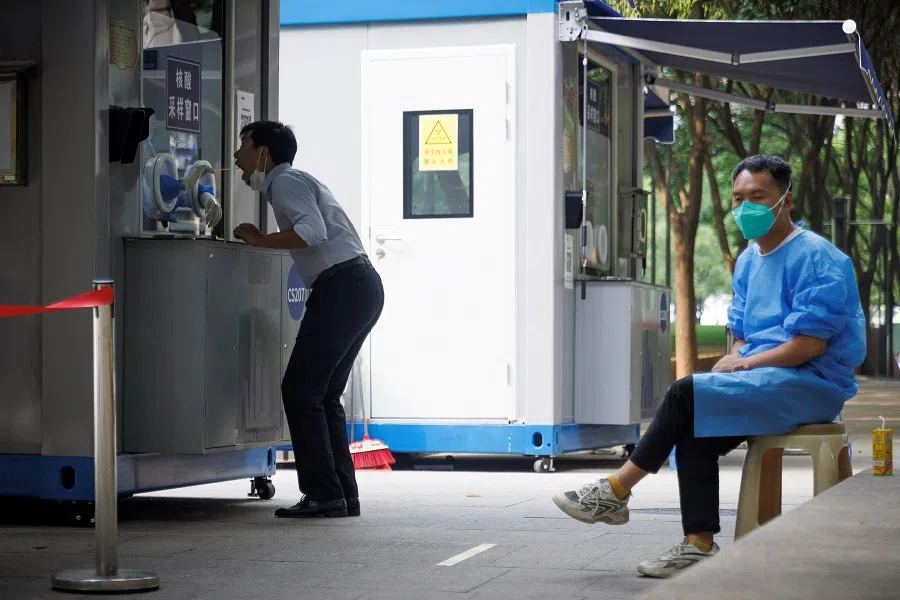A man gets a swab at a nucleic acid testing booth following a Covid-19 outbreak in Beijing, China, 13 September 2022. (Thomas Peter/Reuters)