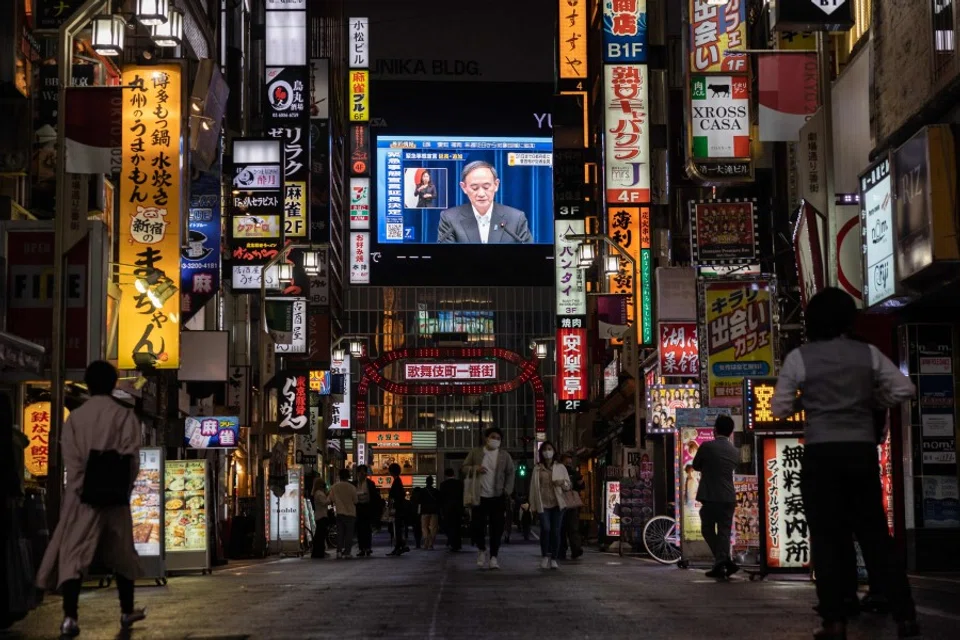 A screen shows Japanese Prime Minister Yoshihide Suga speaking at a press conference in Tokyo on 7 May 2021. (Yuki Iwamura/AFP)