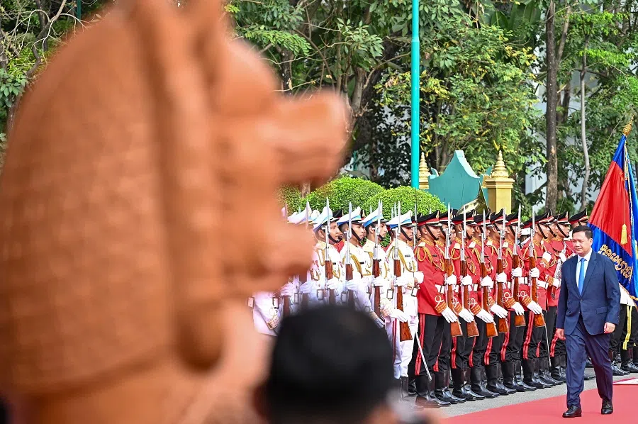 Cambodia’s Prime Minister Hun Manet walks past honour guards upon his arrival at the Senate building during the first meeting of the Senate in Phnom Penh on 3 April 2024.  (Tang Chhin Sothy/AFP)