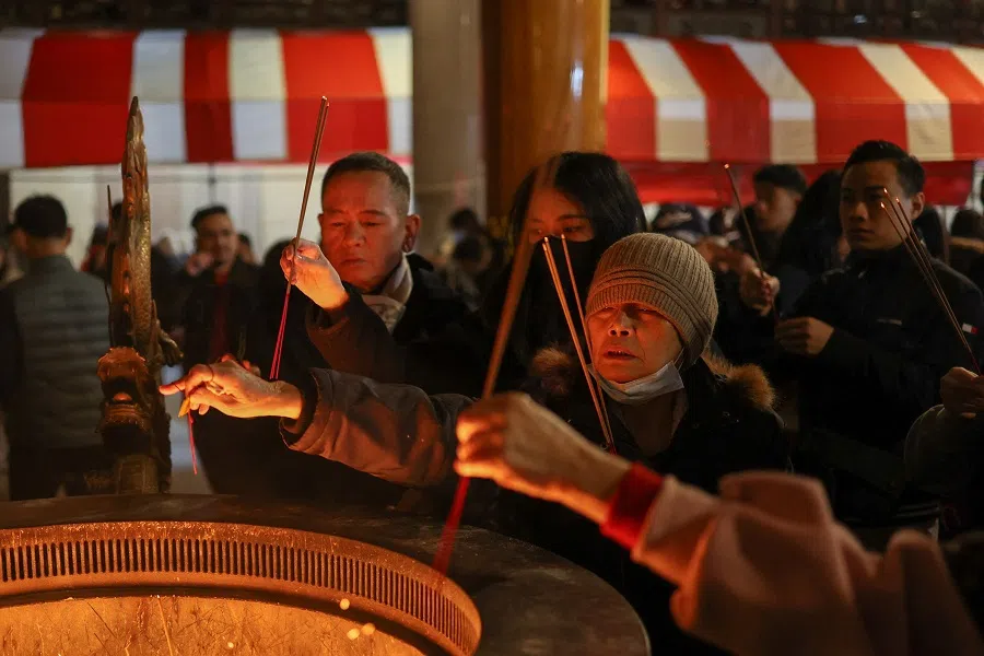 People pray at a temple in New Taipei City, Taiwan, on 9 February 2024. (Ann Wang/Reuters)