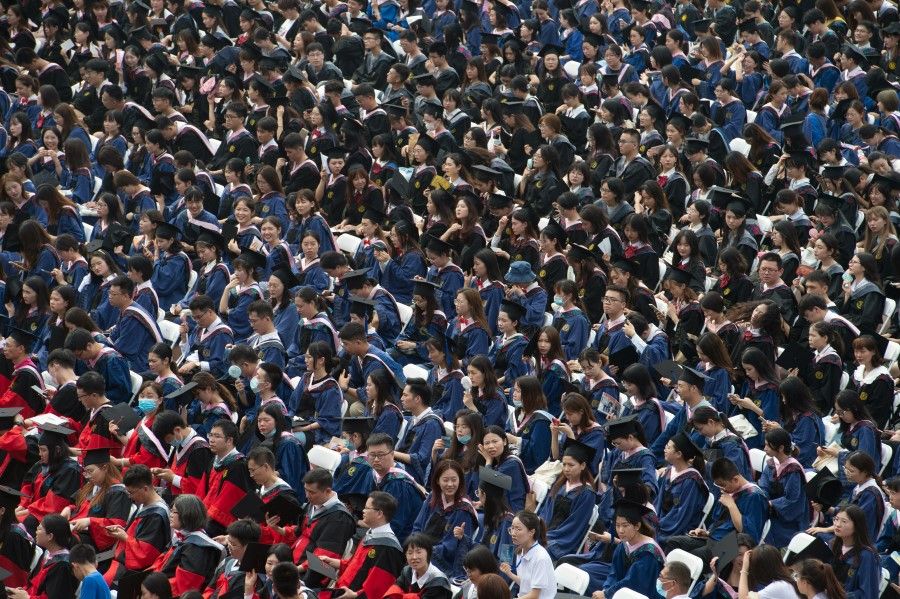 Graduates, including students who could not attend last year due to the coronavirus disease (Covid-19) pandemic, attend a graduation ceremony at Central China Normal University in Wuhan, Hubei province, China, 13 June 2021. (Stringer/Reuters)