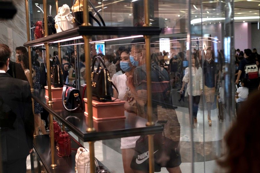Customers looking at the products at a Gucci store at the Sanya International Duty-Free Shopping Complex, in Sanya, Hainan province, China, 27 August 2020. (Carlos Garcia Rawlins/Reuters)