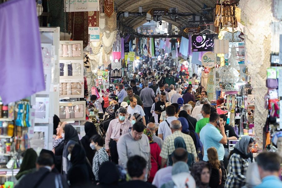 People shop at the Grand Bazaar in Tehran, Iran, on 13 June 2022. (Atta Kenare/AFP)