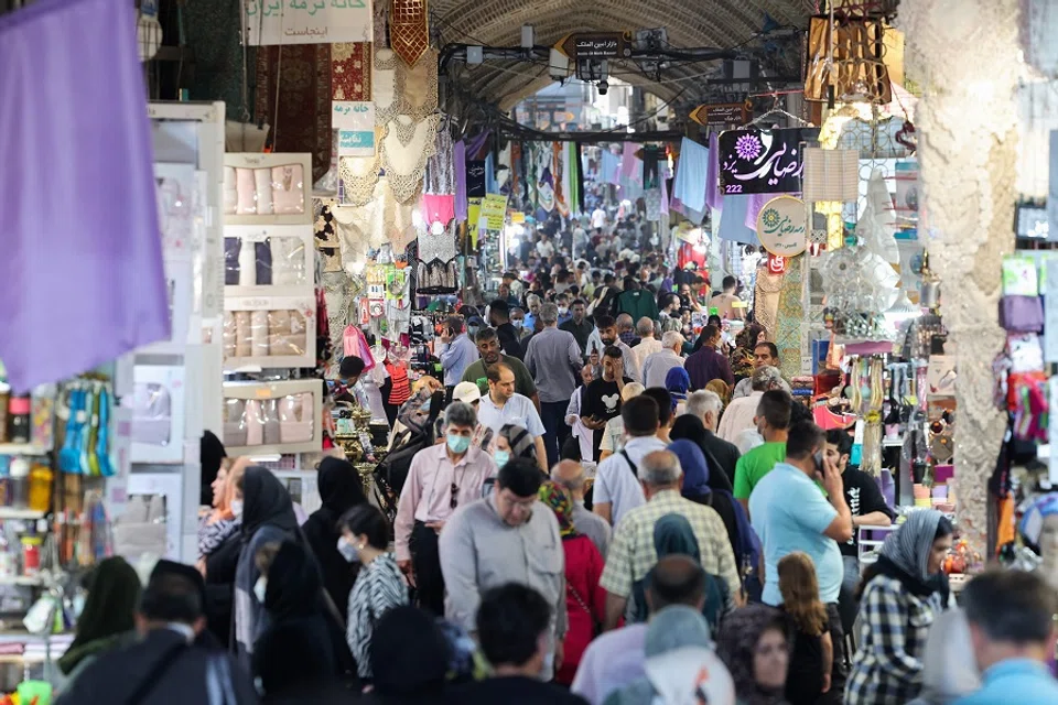 People shop at the Grand Bazaar in Tehran, Iran, on 13 June 2022. (Atta Kenare/AFP)