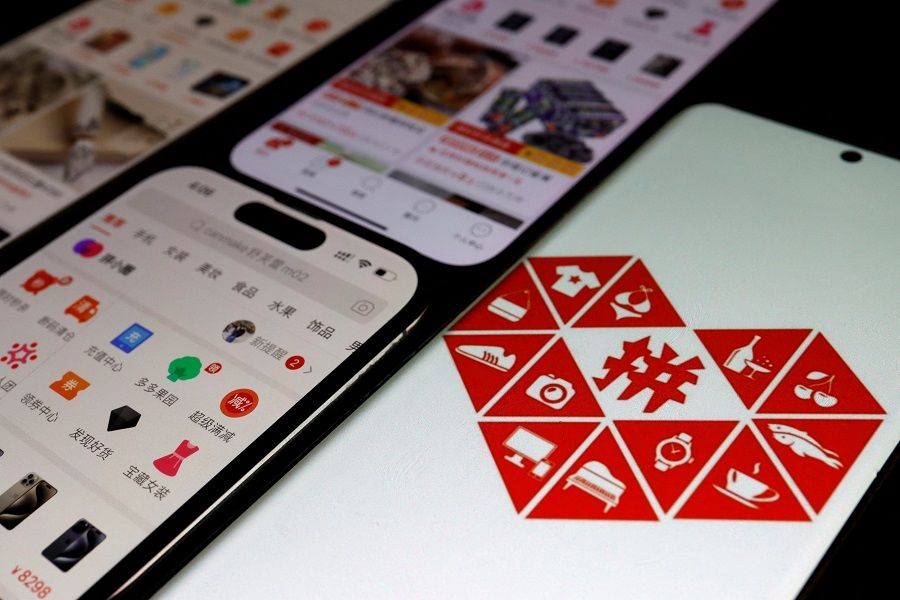 The logo of e-commerce app Pinduoduo is displayed next to mobile phones displaying the app, in this illustration picture taken on 25 October 2023. (Florence Lo/Reuters)