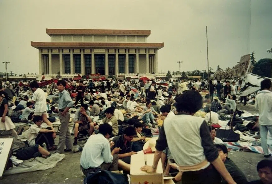 Students sitting on the ground in Tiananmen Square.