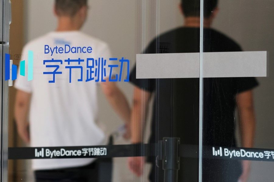 People walk past a logo of Bytedance, the China-based company which owns the short video app TikTok, or Douyin, at its office in Beijing, China, 7 July 2020. (Thomas Suen/Reuters)