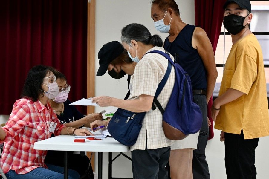 Members of Taiwan's main opposition party Kuomintang (KMT) register before voting to elect a new chairman at a polling station in Taipei on 25 September 2021. (Sam Yeh/AFP)