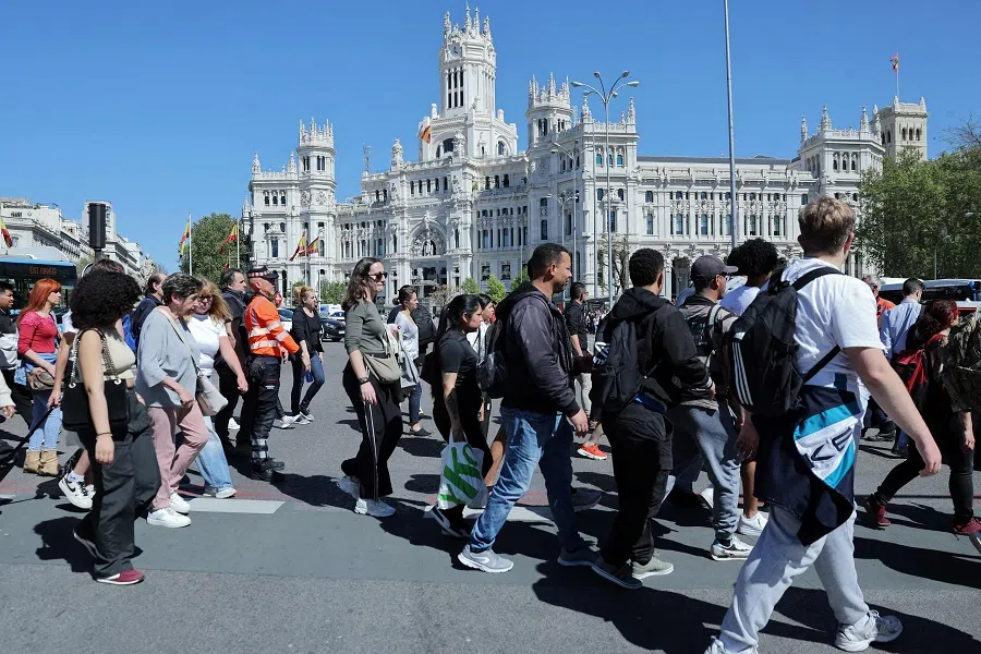 People walk at Plaza de Cibeles in downtown Madrid, Spain on 28 April 2025. (Thomas Coex/AFP)