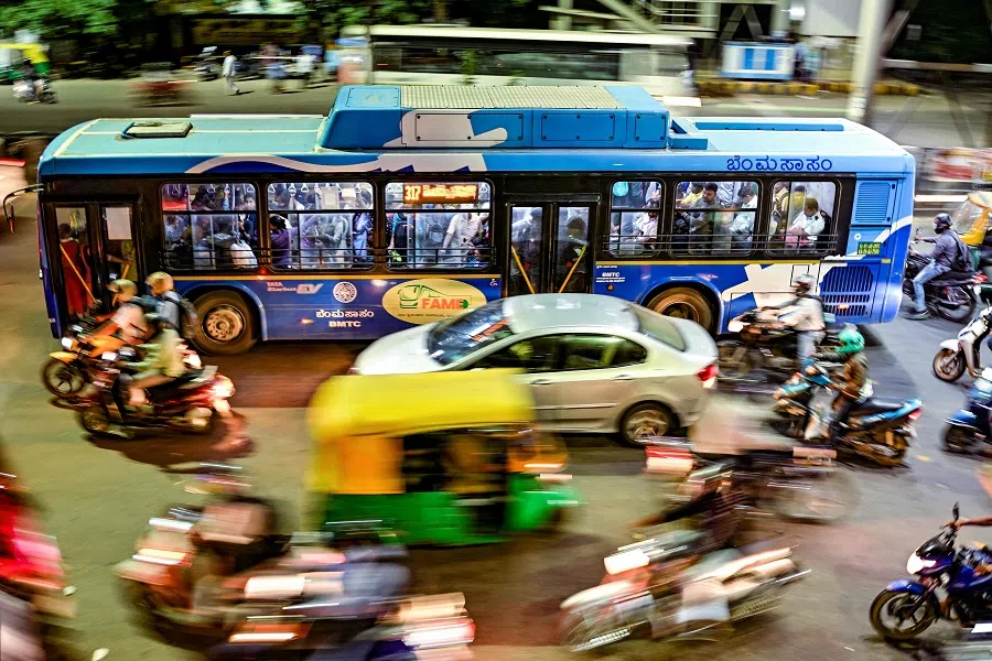 Commuters ride along a street during rush hour in Bengaluru on 12 November 2024.