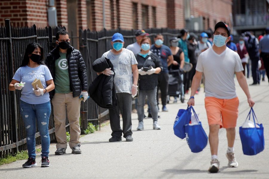 People wait in line at a food bank at St. Bartholomew Church in the Elmhurst section of Queens, New York City, New York, US, on 15 May 2020. (Brendan McDermid/File Photo/Reuters)