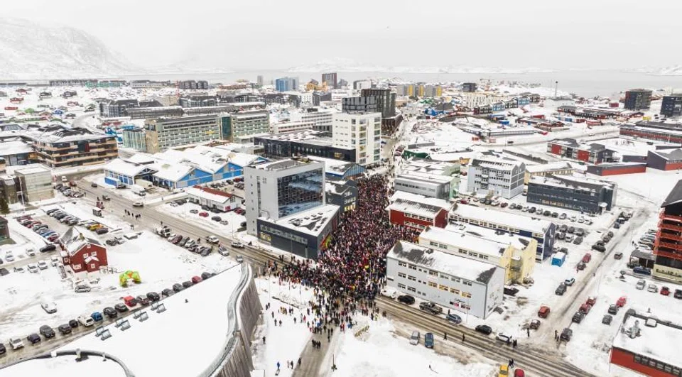 This aerial view taken by Mads Schmidt Rasmussen and handed out by Arctic Creative shows people as they take part in a demonstration that gathered almost a third of the city population to protest against the US President’s plans to take Greenland, on 17 January 2026 in Nuuk, Greenland. (Mads Schmidt Rasmussen/AFP)