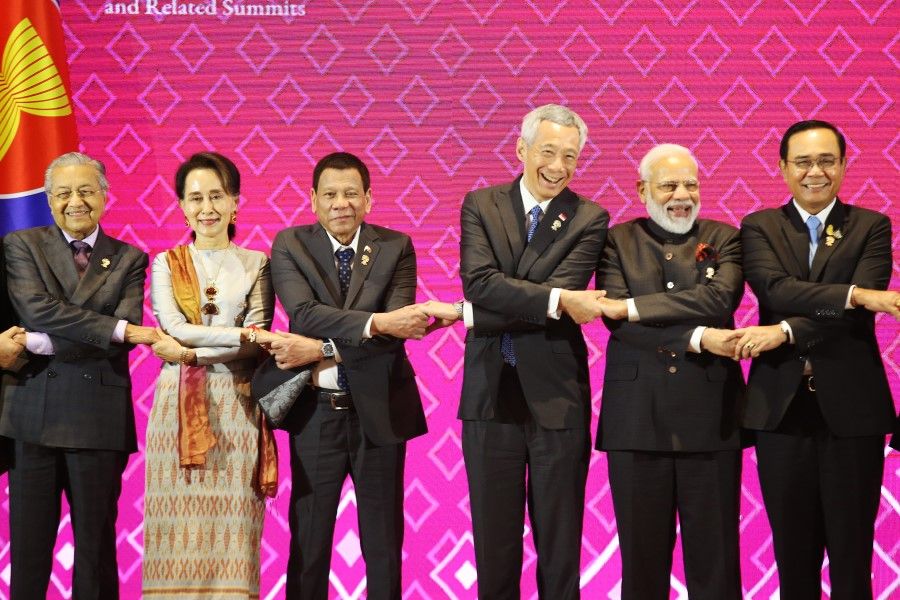 (From left) Malaysian Prime Minister Mahathir Mohamad, Myanmar's State Counsellor and Foreign Minister Aung San Suu Kyi, Philippine President Rodrigo Duterte, Singapore Prime Minister Lee Hsien Loong, Indian Prime Minister Narendra Modi and Thai Prime Minister Prayuth Chan-ocha link hands during a group photo at the 16th Asean Summit on 3 Nov 2019 in Nonthaburi, Thailand. (SPH)