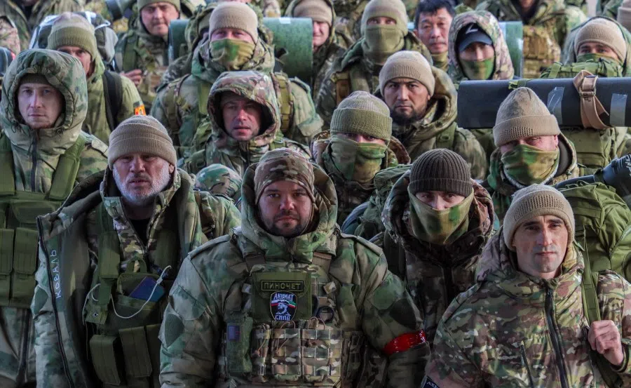 Volunteers, who joined the Russian armed forces and took military training in Chechnya, board a plane before departing for positions of the Akhmat battalion involved in Russia's military campaign in Ukraine, at an airport in Grozny, Russia, on 17 January 2024. (Chingis Kondarov/Reuters)