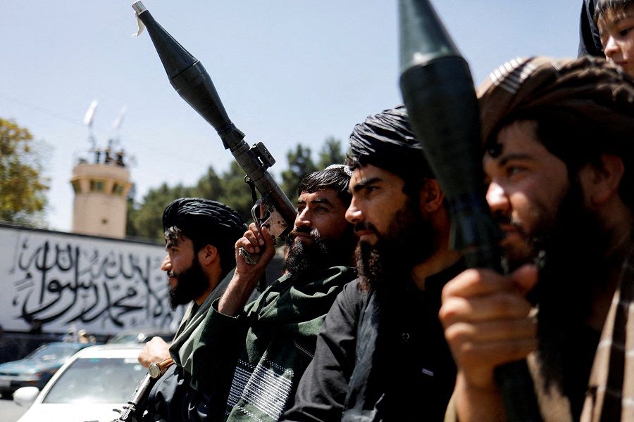 Taliban soldiers celebrate on the second anniversary of the fall of Kabul on a street near the US embassy in Kabul, Afghanistan, on 15 August 2023. (Ali Khara/Reuters)