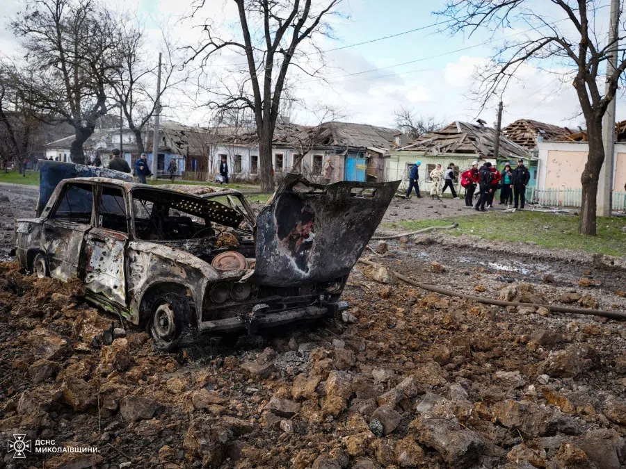 A destroyed car and damaged residential buildings are seen at the site of a Russian missile strike, amid Russia's attack on Ukraine, in Mykolaiv, Ukraine, on 17 March 2024. (Press service of the State Emergency Service of Ukraine in Mykolaiv region/Handout via Reuters)