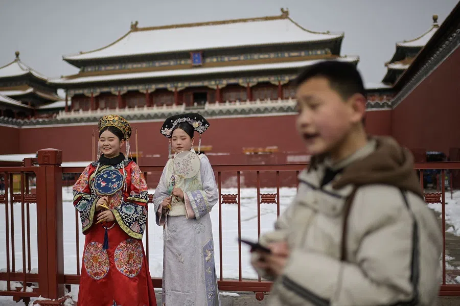 Women wearing traditional costumes visit the Forbidden City in Beijing, China, on 21 February 2024. (Pedro Pardo/AFP)