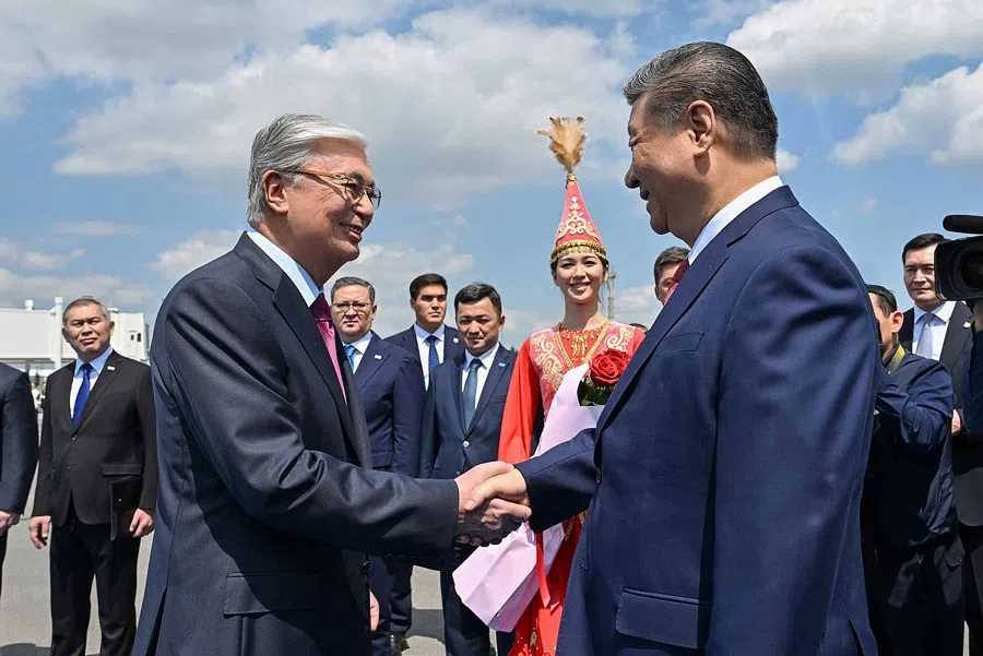 Kazakhstan’s President Kassym-Jomart Tokayev shakes hands with China’s President Xi Jinping upon his arrival at the airport in Astana on 16 June 2025, to attend the second China-Central Asia Summit.