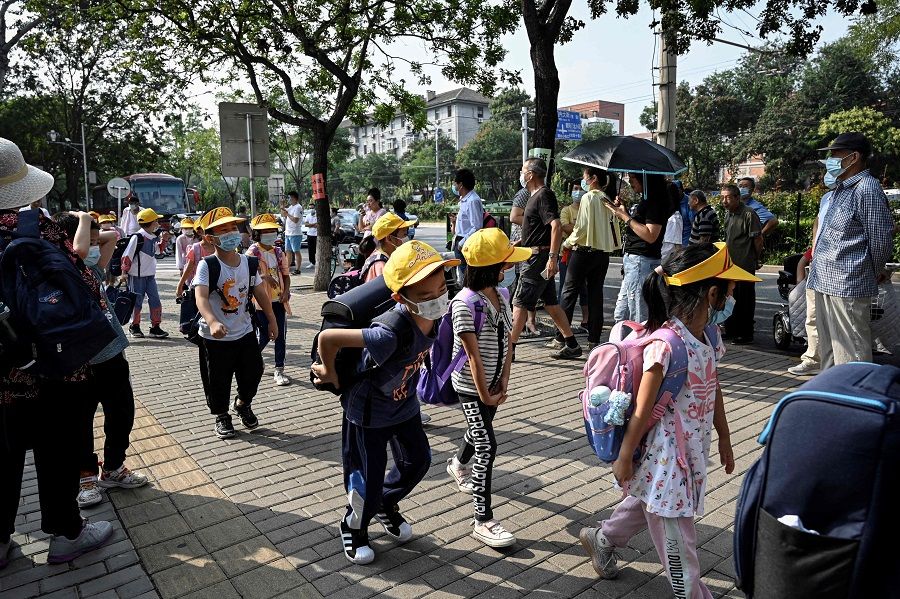 Children leave school following the end of the day's lesson in Beijing, China, on 10 September 2021. (Jade Gao/AFP)