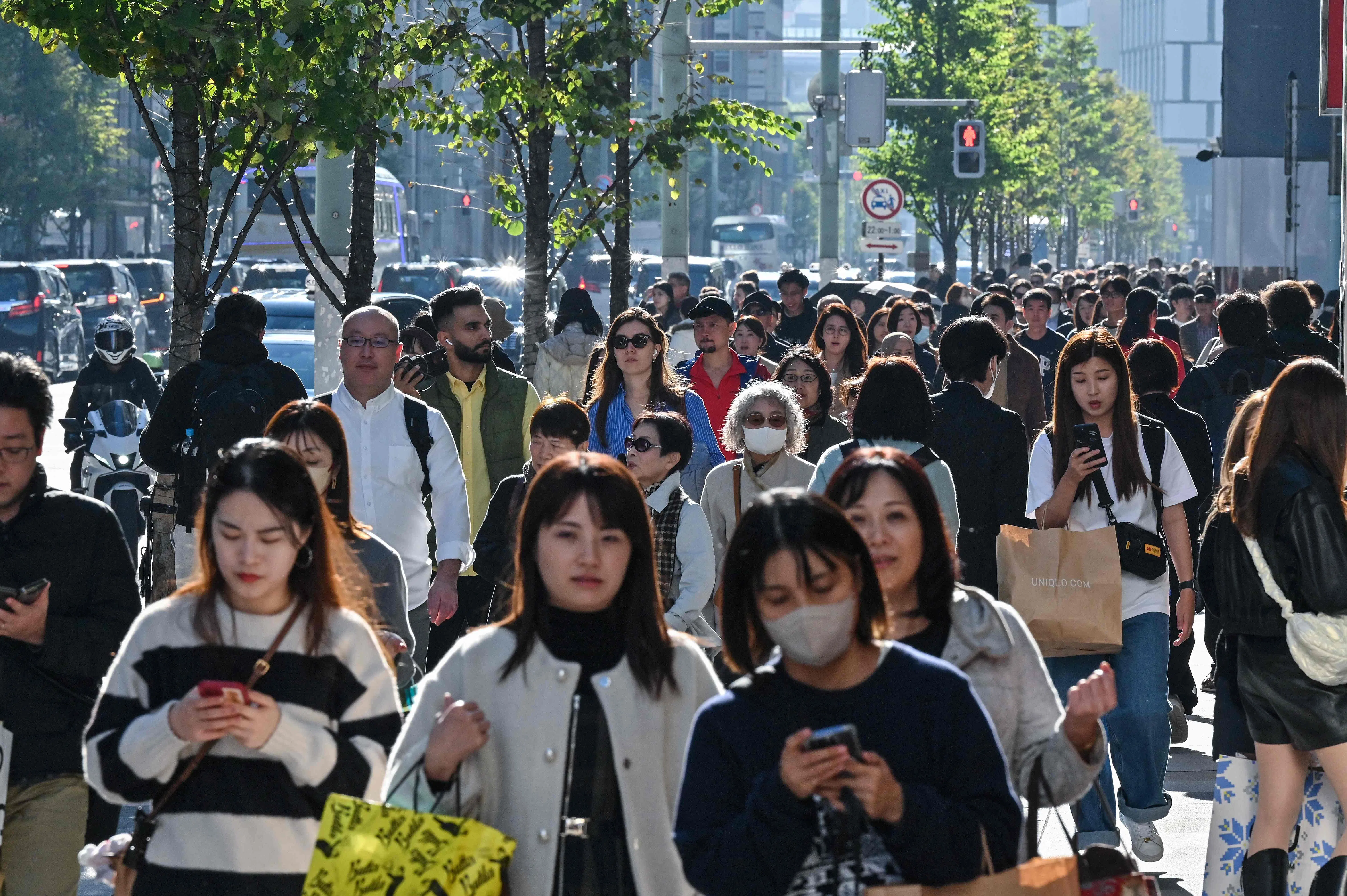 Pedestrians walk down the high-street shopping area of the Ginza district in central Tokyo on 22 November 2024. (Richard A. Brooks/AFP)