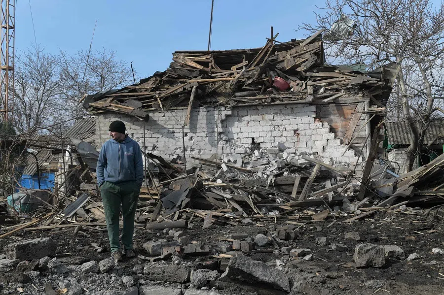 A man stands in the yard of a destroyed house following recent shelling, on the outskirts of Yenakiieve in the Donetsk region, Russian-controlled Ukraine, on 5 March 2025, amid the ongoing Russia-Ukraine conflict.