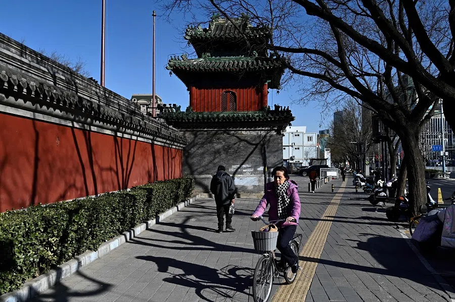 People are seen outside Dongyue temple in Beijing on 13 February 2025. (Pedro Pardo/AFP)
