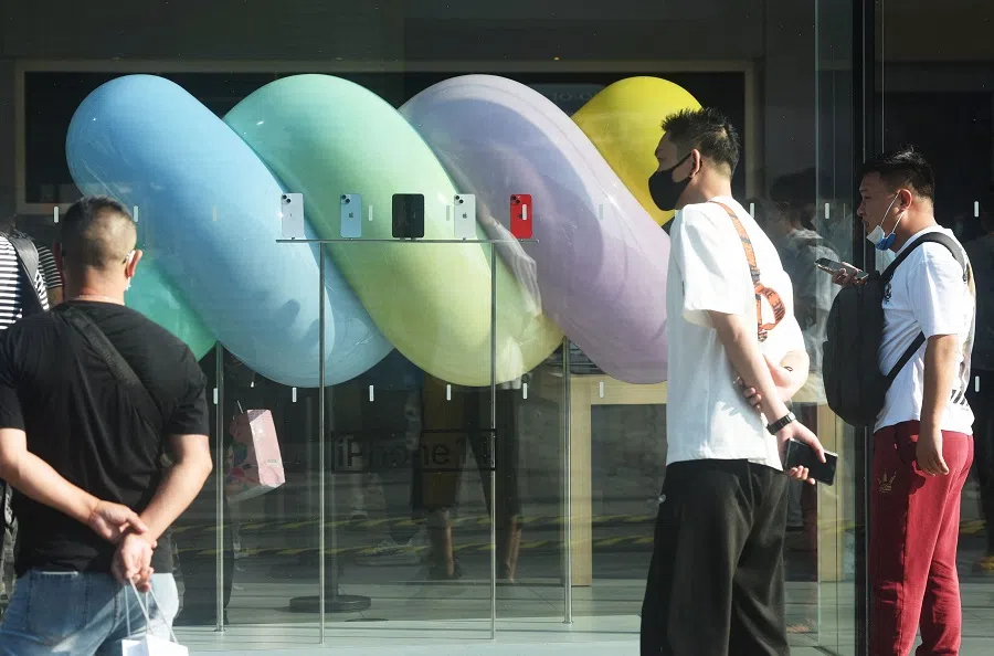 Customers look at newly-launched iPhone 14 mobile phones at an Apple store in Hangzhou, Zhejiang province, China, on 16 September 2022. (AFP)