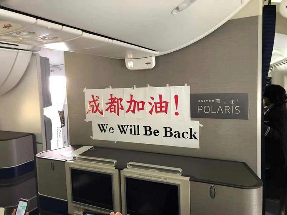 The last flight we took from Chengdu to San Francisco. The banner reads: "Chengdu, you can do it! We will be back".