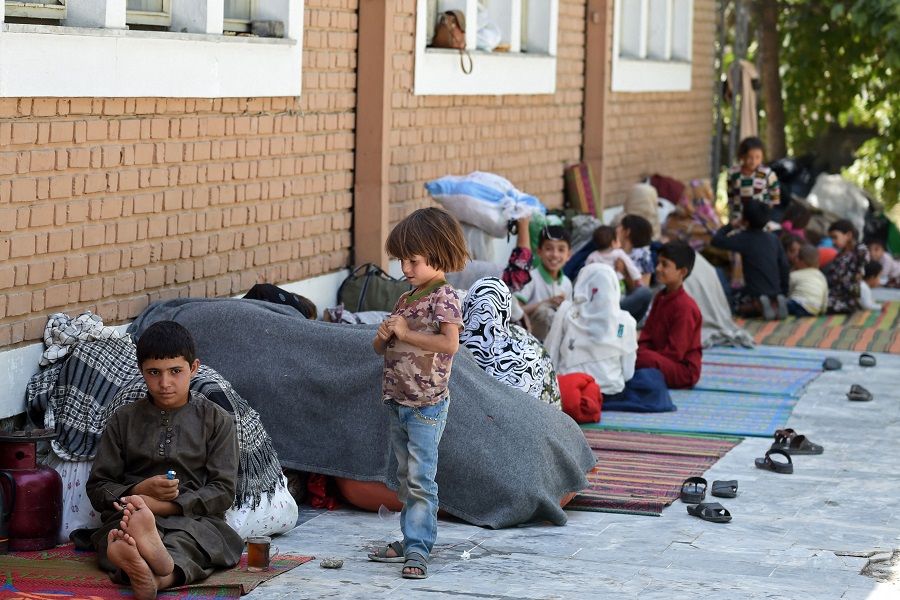 Internally displaced Afghan families, who fled from the northern province due to battle between Taliban and Afghan security forces, sit in the courtyard of the Wazir Akbar Khan mosque in Kabul, Afghanistan on 13 August 2021. (Wakil Kohsar/AFP)
