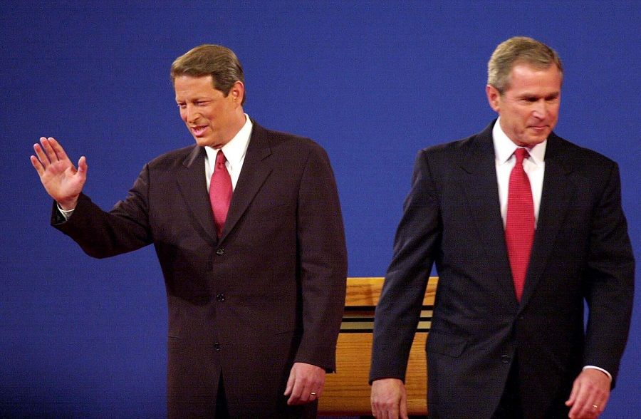 In this file photo taken on 2 October 2000, Republican presidential candidate George W. Bush (right) and Democratic presidential candidate Al Gore move to their spots to begin their 3 October 2000 debate at the University of Massachusetts Boston. (John Mottern/AFP)