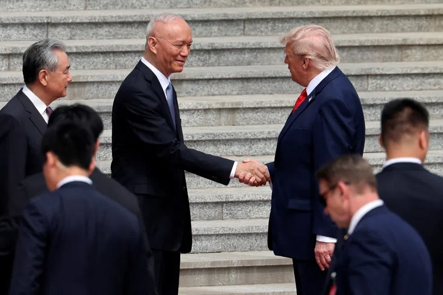US President Donald Trump shakes hands with Politburo Standing Committee member Cai Qi during a welcome ceremony at the Great Hall of the People in Beijing, China, on 14 May 2026.